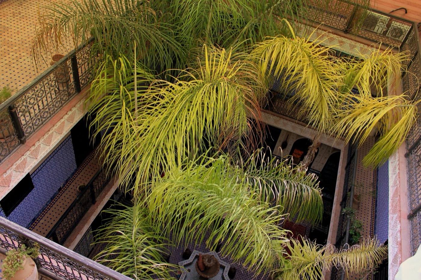 Trip planning on a Moroccan riad rooftop with a phone, map and mint tea