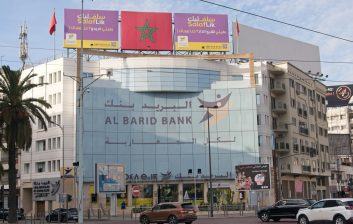 Bank ATM in a Moroccan city street being used in daylight