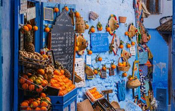 Blue fishing boats and fishermen in Essaouira harbour, Morocco