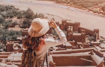 Traveller checking a banking app on a phone on a Moroccan rooftop terrace
