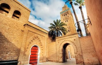 Ochre ramparts and stork nests in the Kasbah quarter of Marrakech in late afternoon light