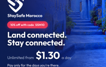 Traveller messaging home on arrival at a Moroccan riad courtyard